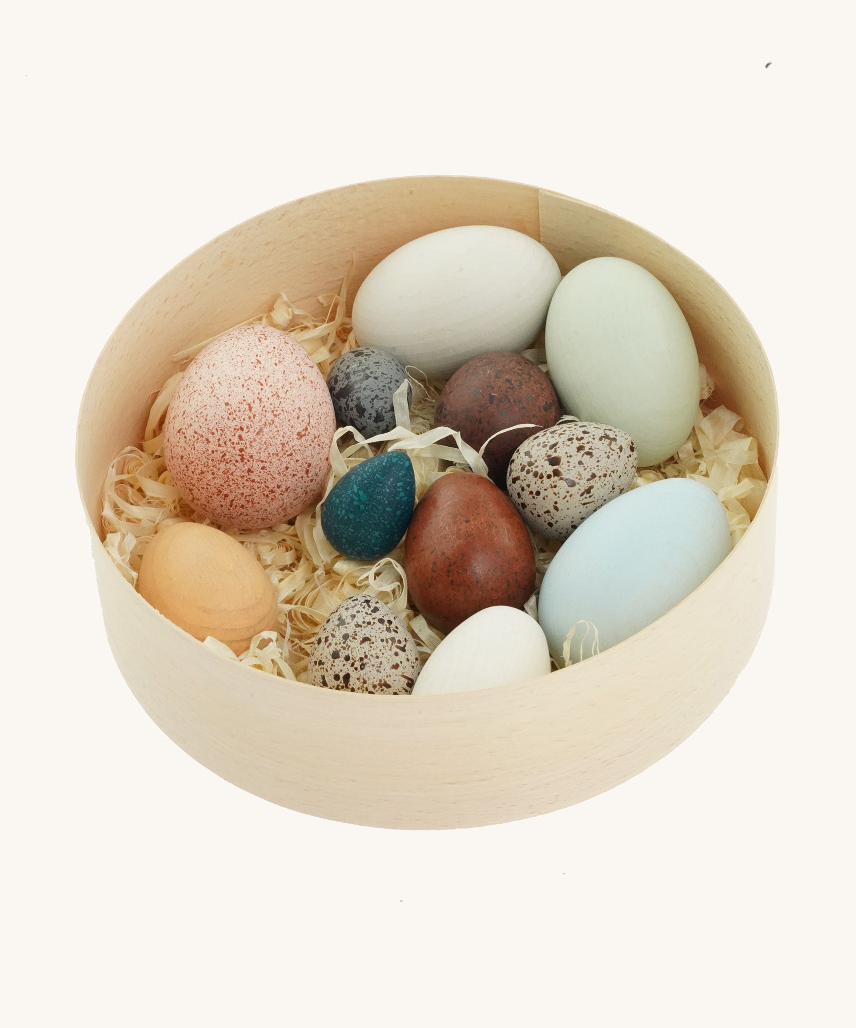 A wooden basket filled with a dozen uniquely painted wooden duck eggs from Erzi.