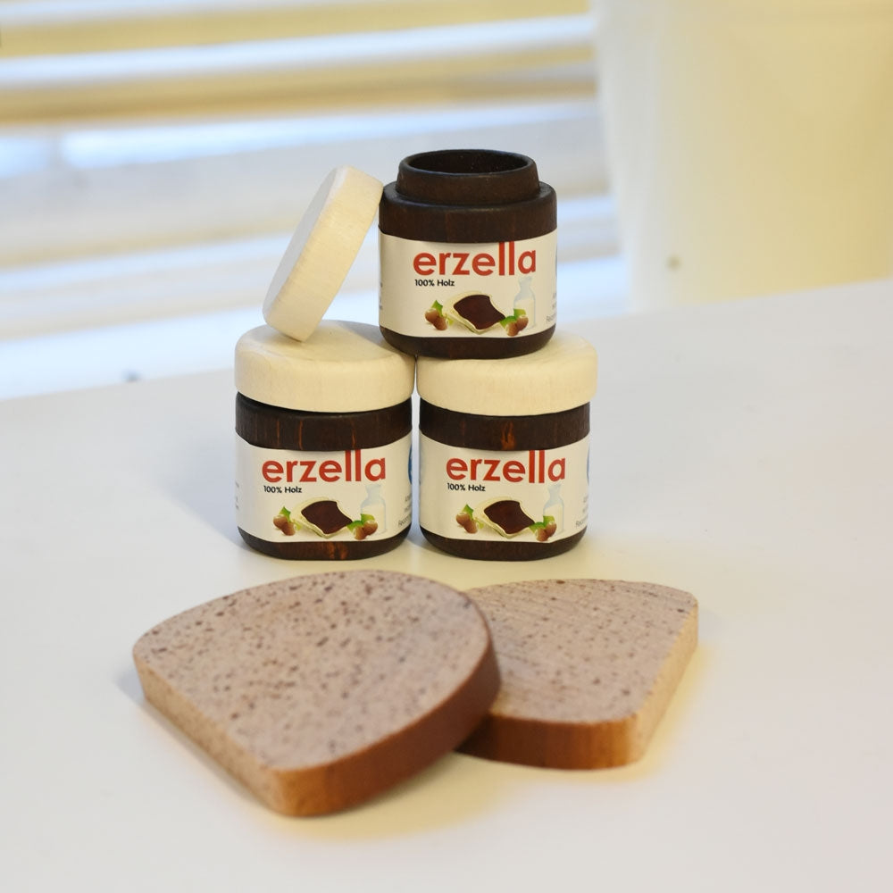 Three jars of Erzi Erzella Chocolate Spread Wooden Play Food stacked up