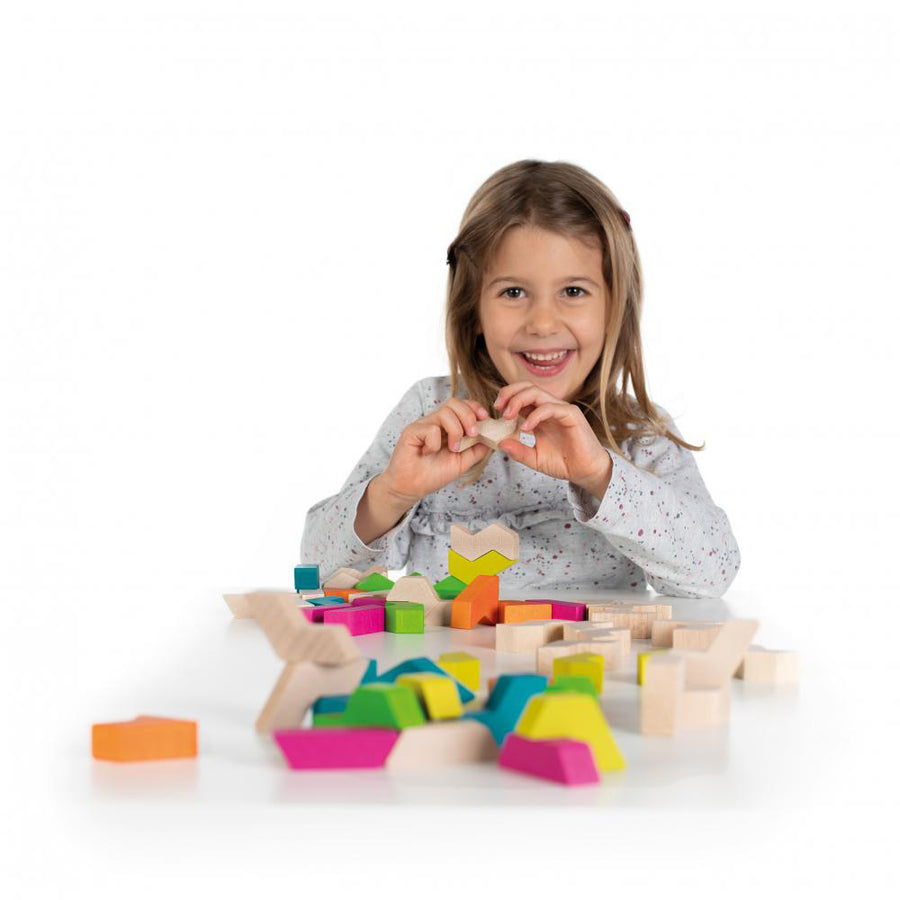 Girl playing with the Erzi sustainably sourced wooden maxi geoblocks on a white background