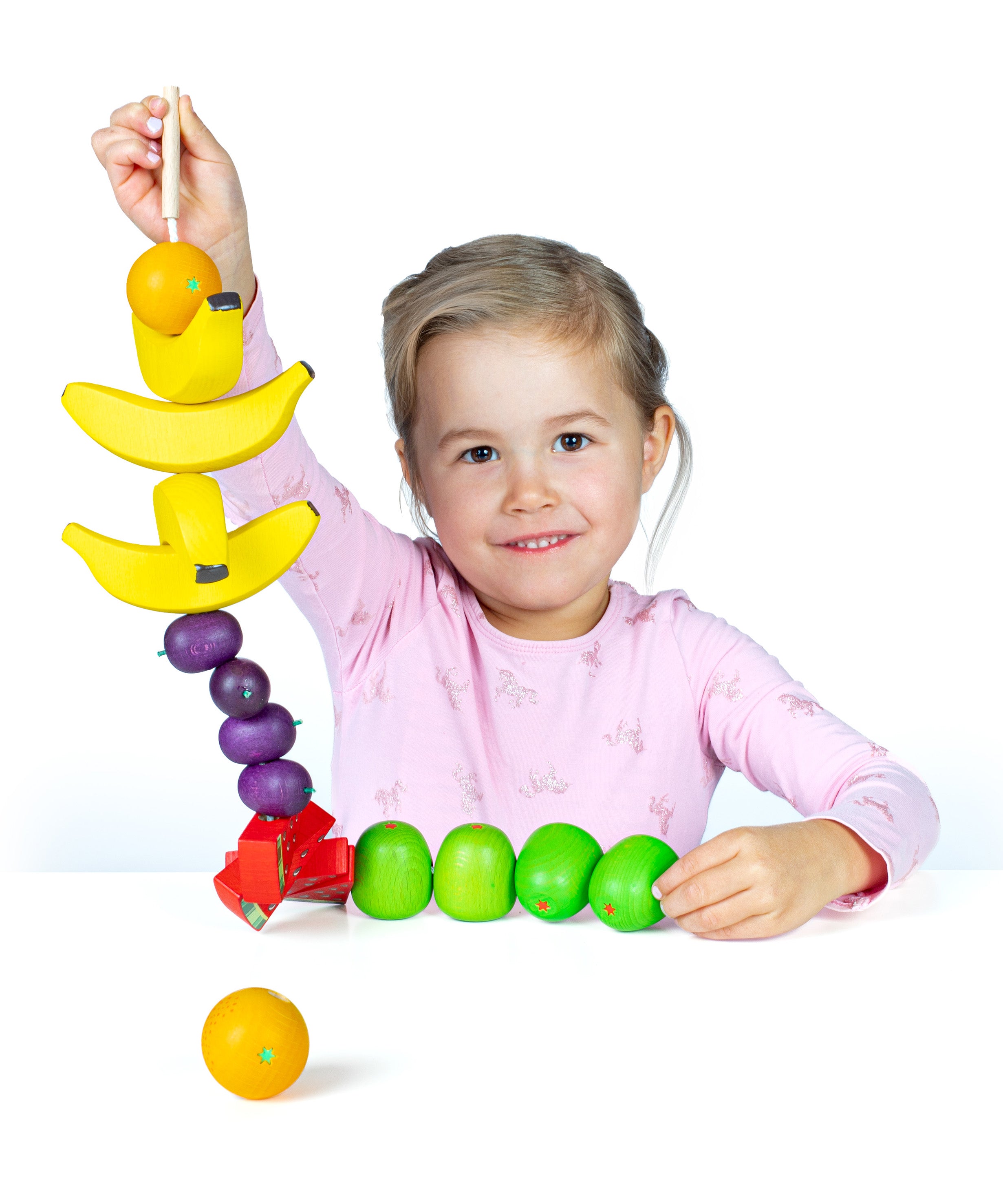 Erzi wooden threading fruits educational game played with a child