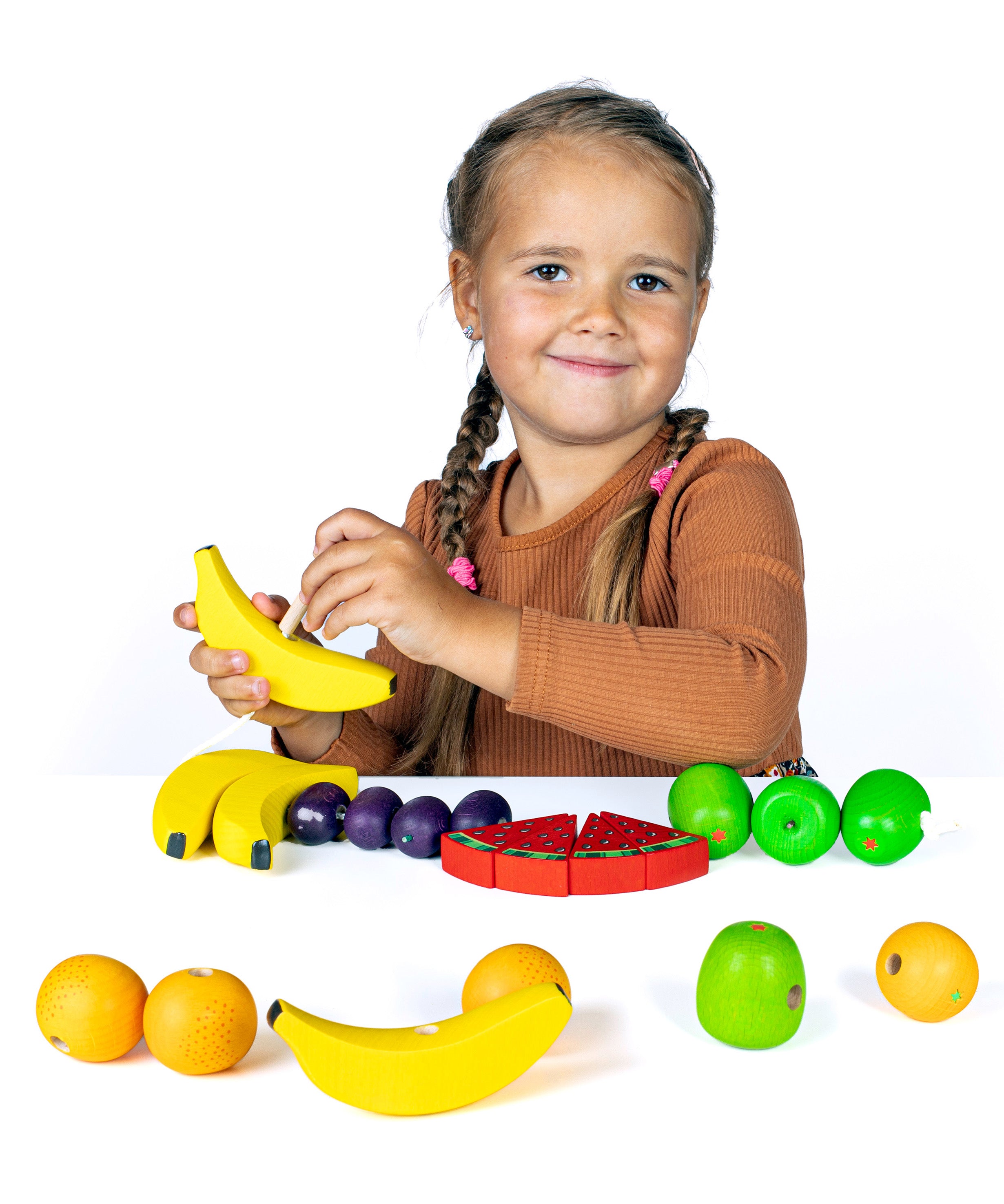 Erzi wooden threading fruits educational game played with a child