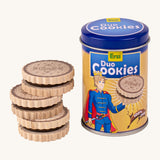 Erzi wooden duo cookies stacked next to tin packaging on a cream background.