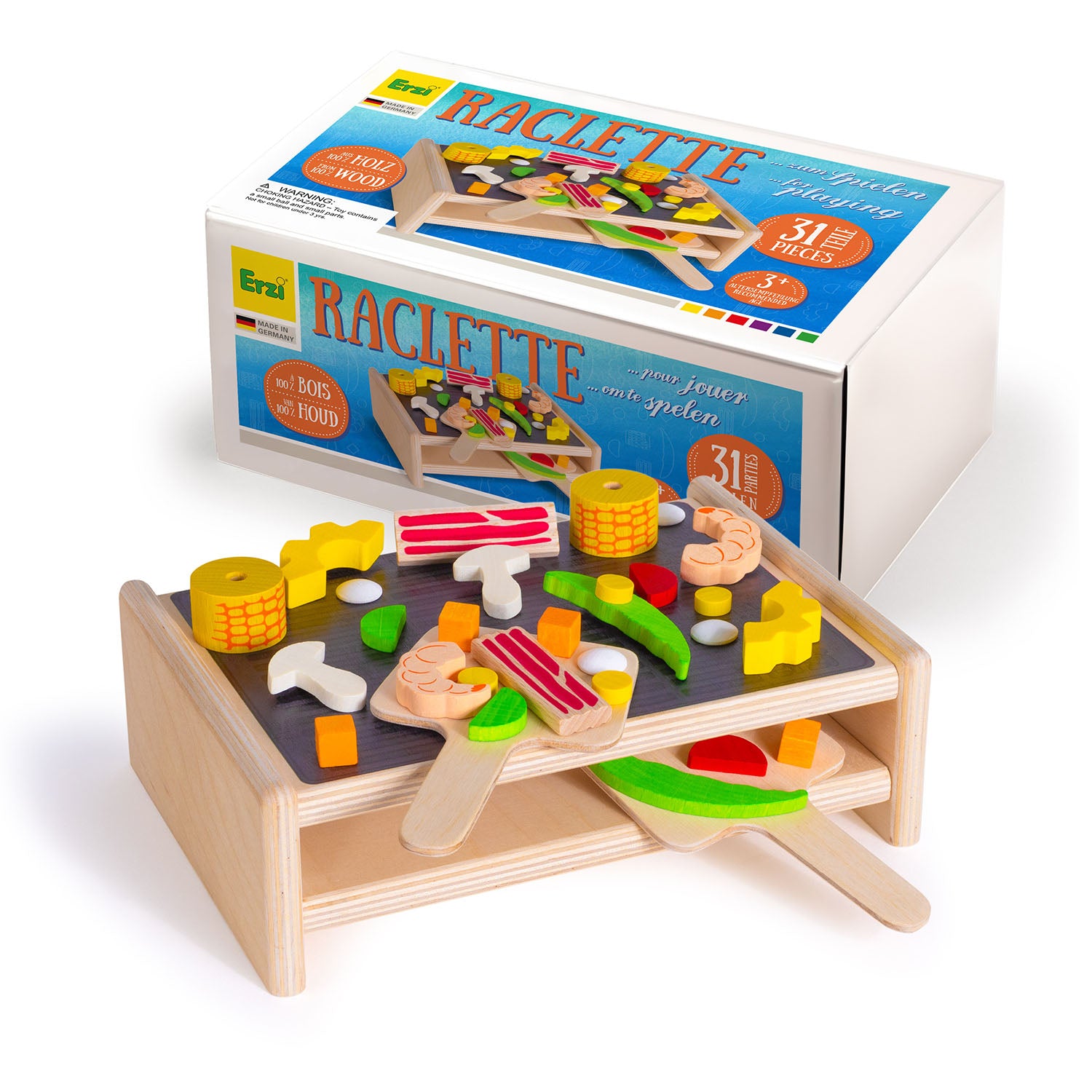 Erzi Wooden Play Food Set - Raclette Grill set in front of the packaging box. This yummy set includes sweetcorn