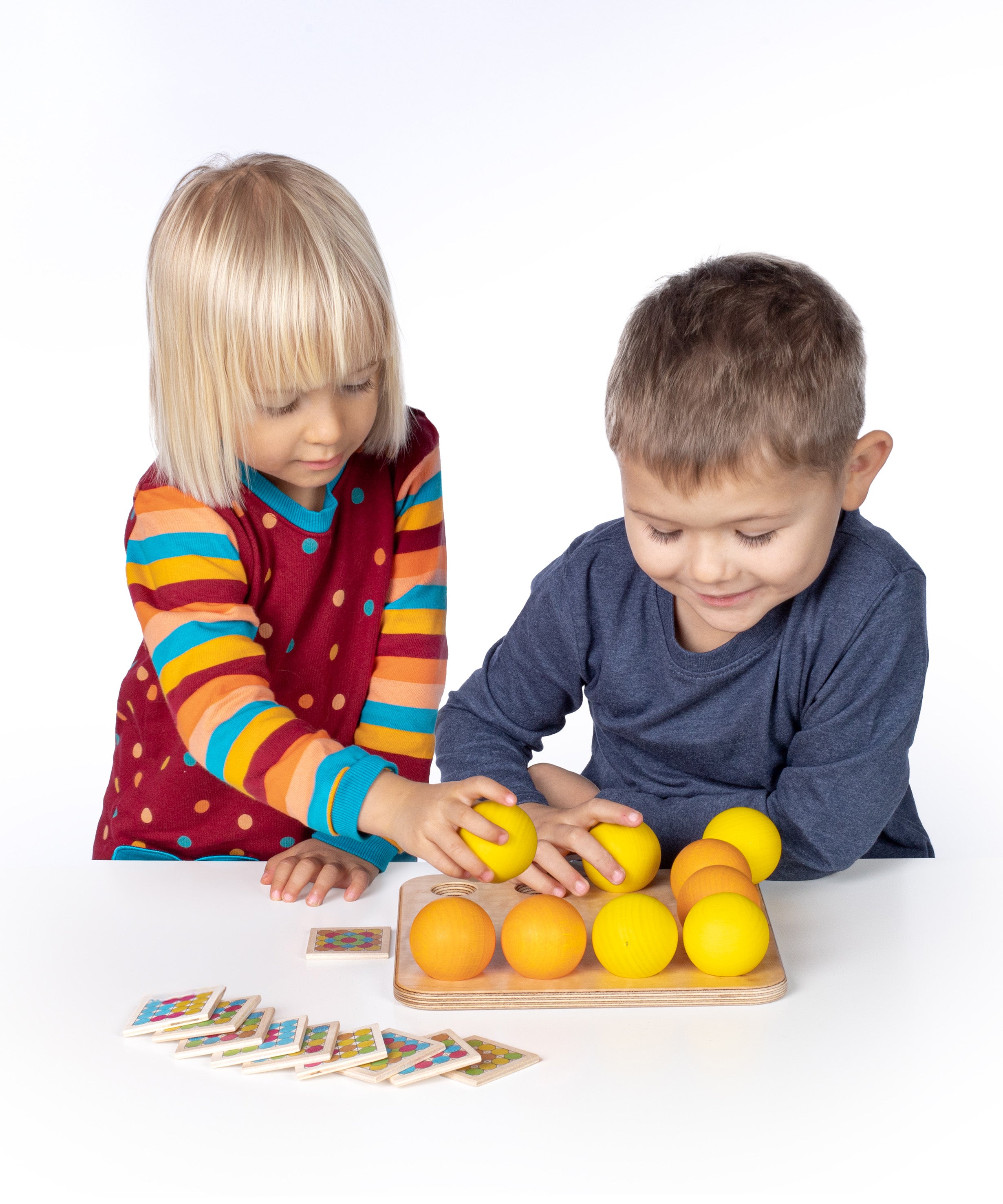 Erzi wooden multicoloured balls stacking game on a wooden base played with by 2 children