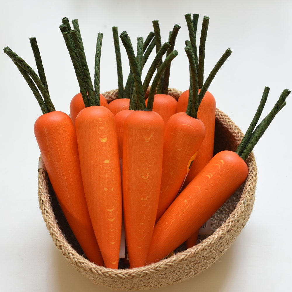 A Respiin bowl filled with Erzi Carrot Wooden Play Food.