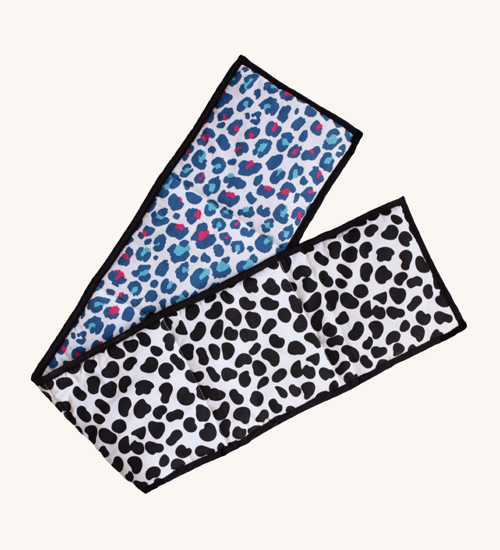 Etta Loves Organic Cotton Reversible Baby Sensory Strip - Animal Print, with a black, spotted Dalmatian print on one side, and a colourful red and light blue Leopard print on the other