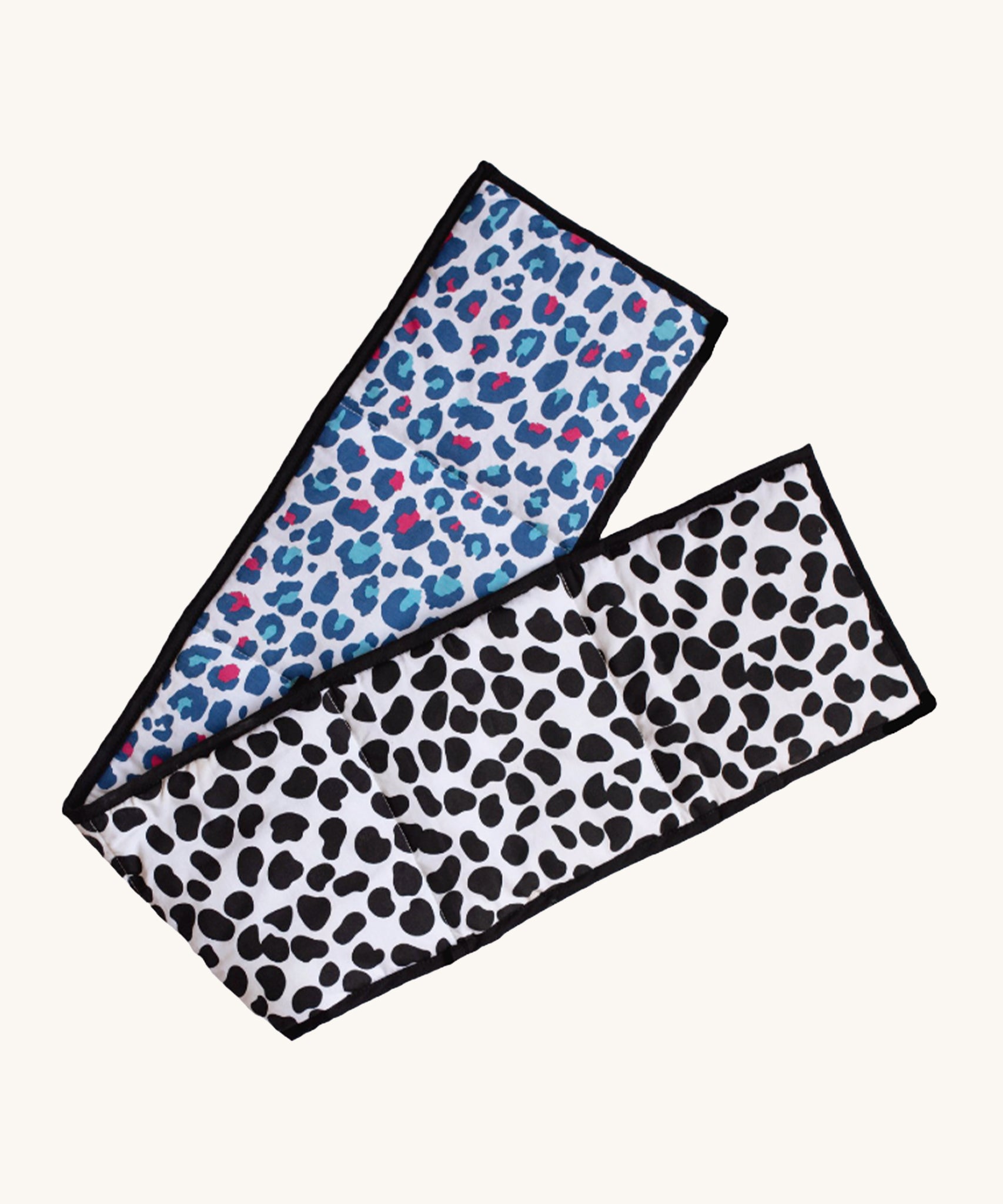 Etta Loves Organic Cotton Reversible Baby Sensory Strip - Animal Print, with a black, spotted Dalmatian print on one side, and a colourful red and light blue Leopard print on the other