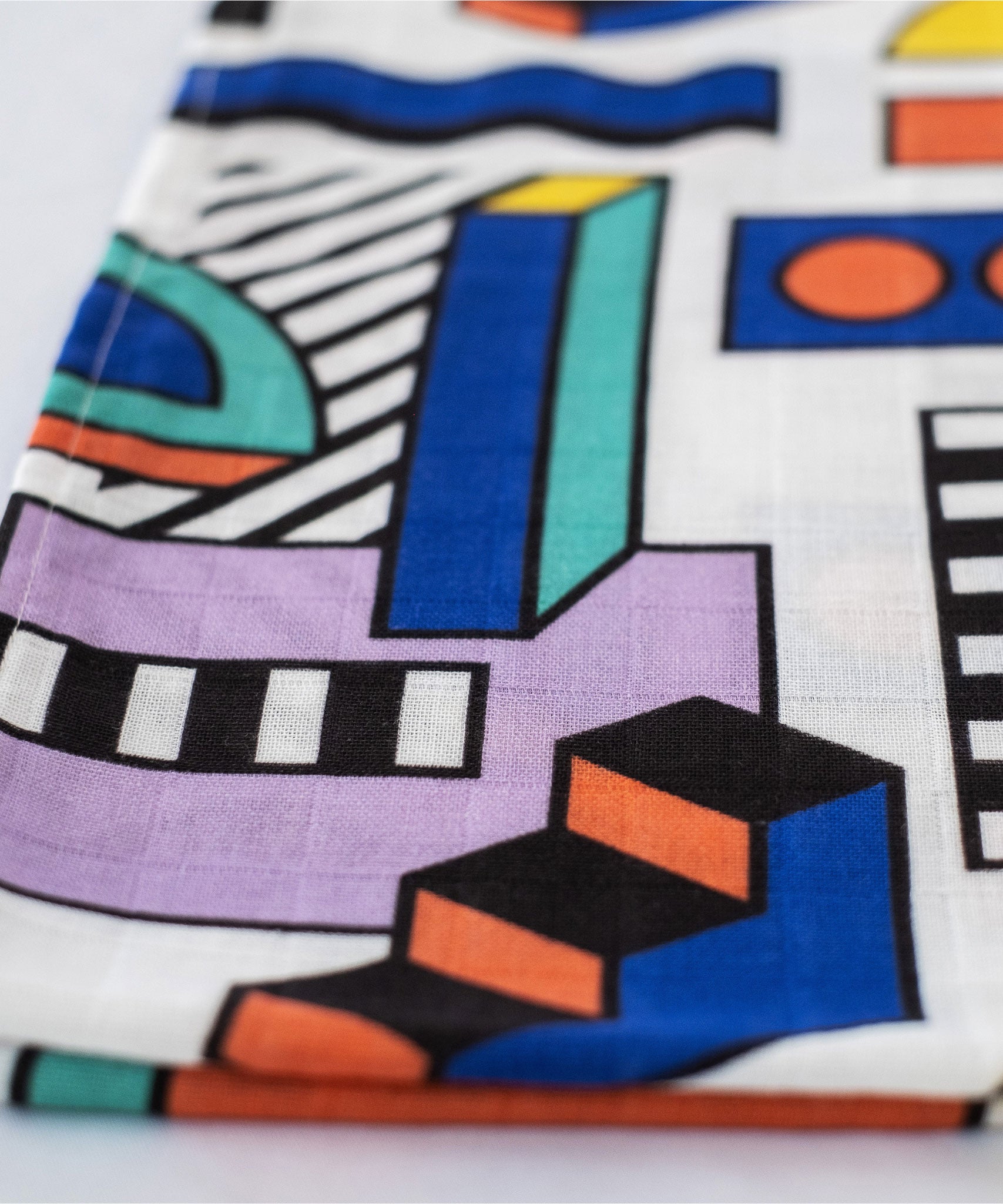 A close up of the pattern featured on the Etta Loves x Camille Walala Muslin Blanket.