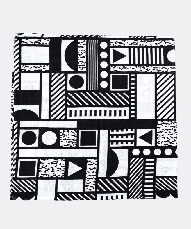 The Etta Loves x Camille Walala XL Muslin Square - Mono folded up into a square on a plain background. 