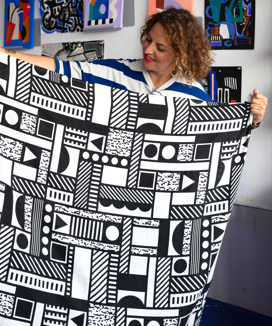 Camille Walala holding up an Etta Loves x Camille Walala XL Muslin Square - Mono