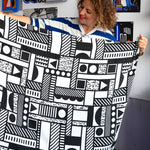 Camille Walala holding up an Etta Loves x Camille Walala XL Muslin Square - Mono