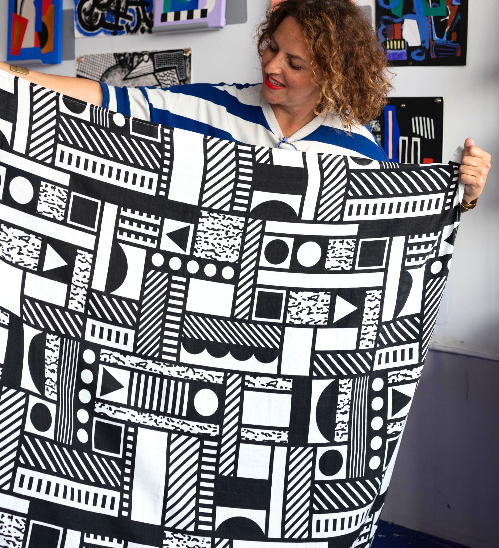 Camille Walala holding up an Etta Loves x Camille Walala XL Muslin Square - Mono