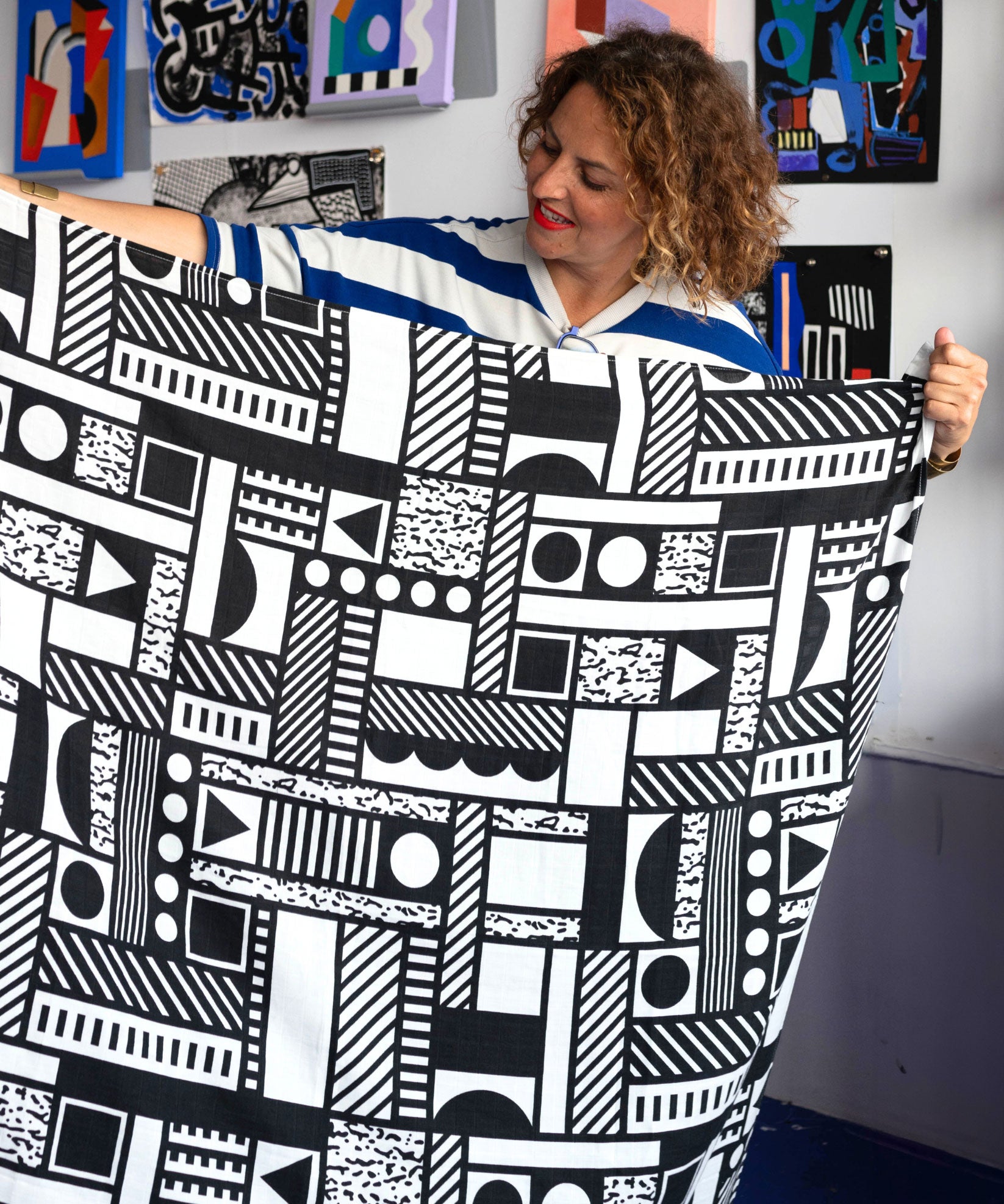 Camille Walala holding up an Etta Loves x Camille Walala XL Muslin Square - Mono