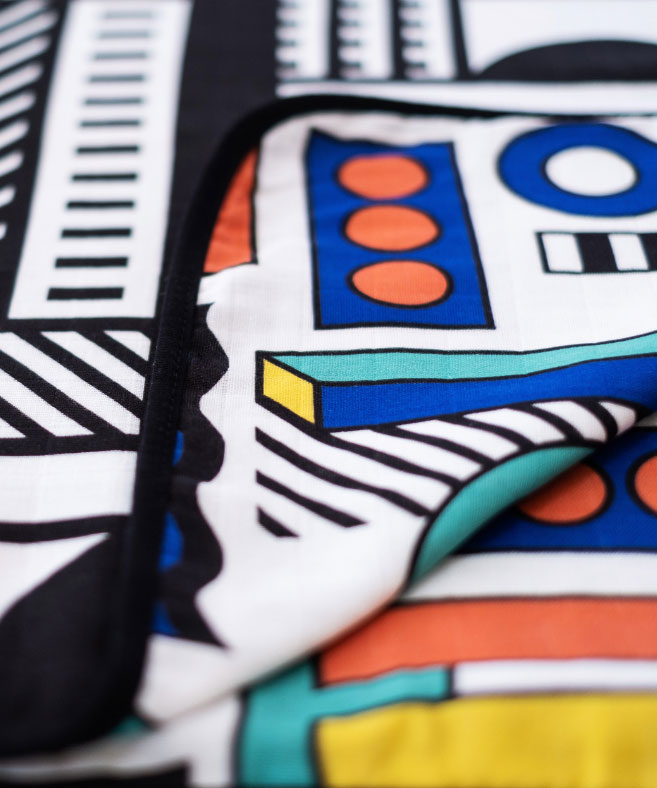 A close up of the coloured side of the Etta Loves x Camille Walala Muslin Blanket.