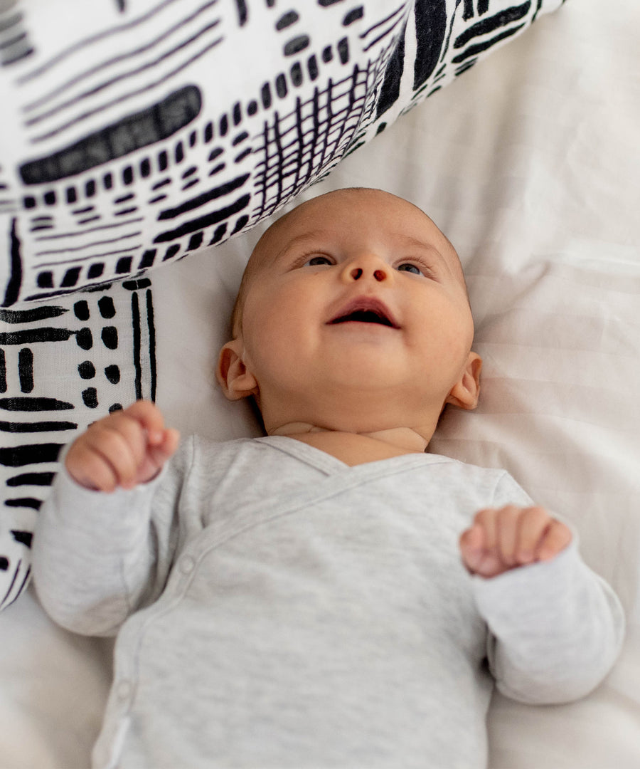 A closer look at the faces print from the Etta Loves Organic Cotton Baby Muslin Squares 3 Pack - Drawing Print