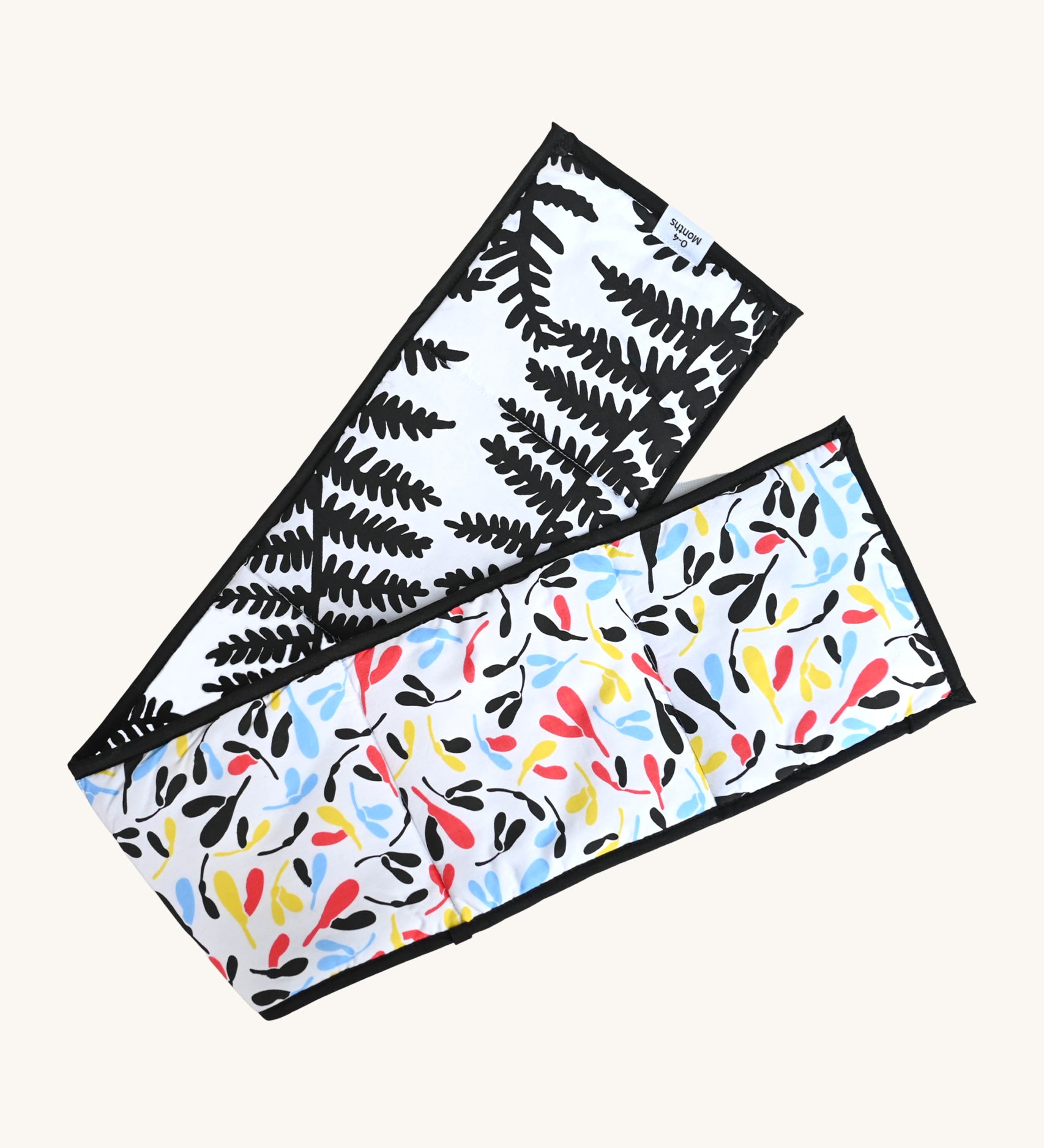 Etta Loves Organic Cotton Reversible Sensory Strip - Plant Print, with a colourful Sycamore print on one side, and a striking and bold black fern print on the other