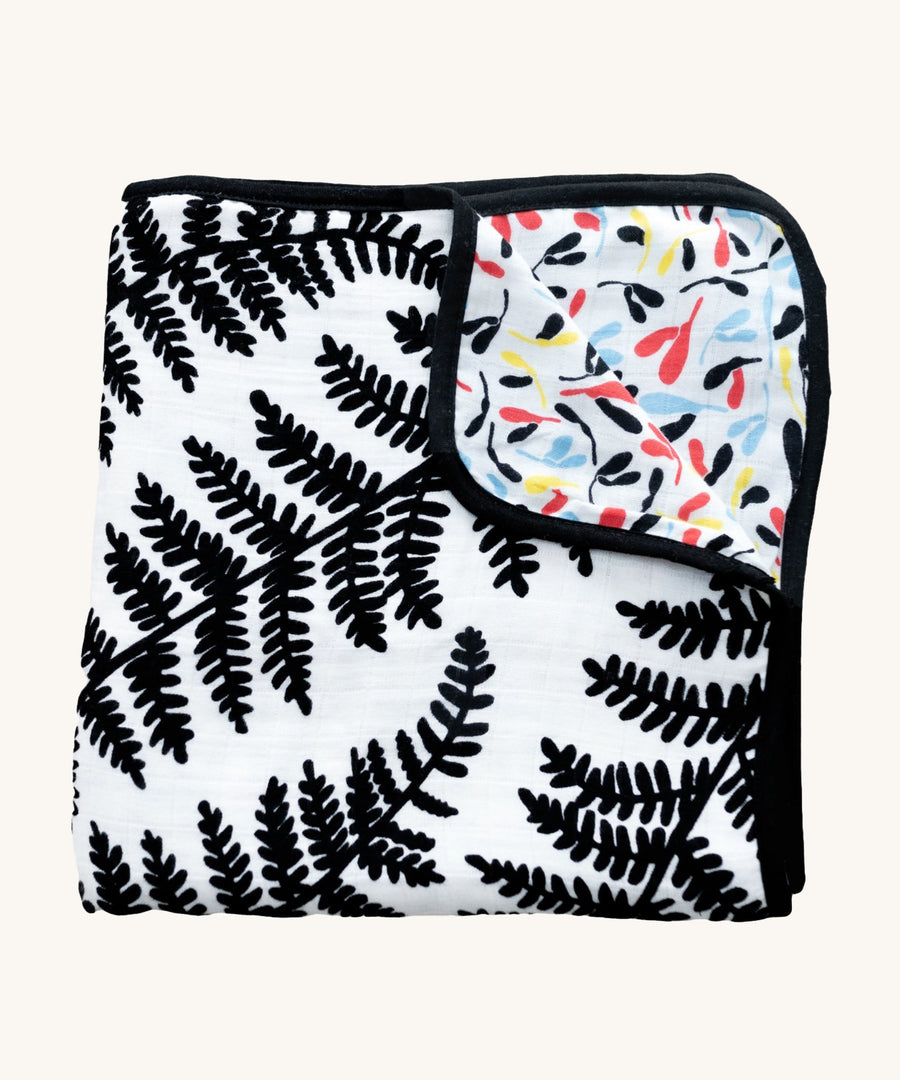 Etta Loves Reversible Organic Cotton Muslin Blanket - Plant Print with black and white Ferns on one side, and colourful Sycamore seeds print on the other