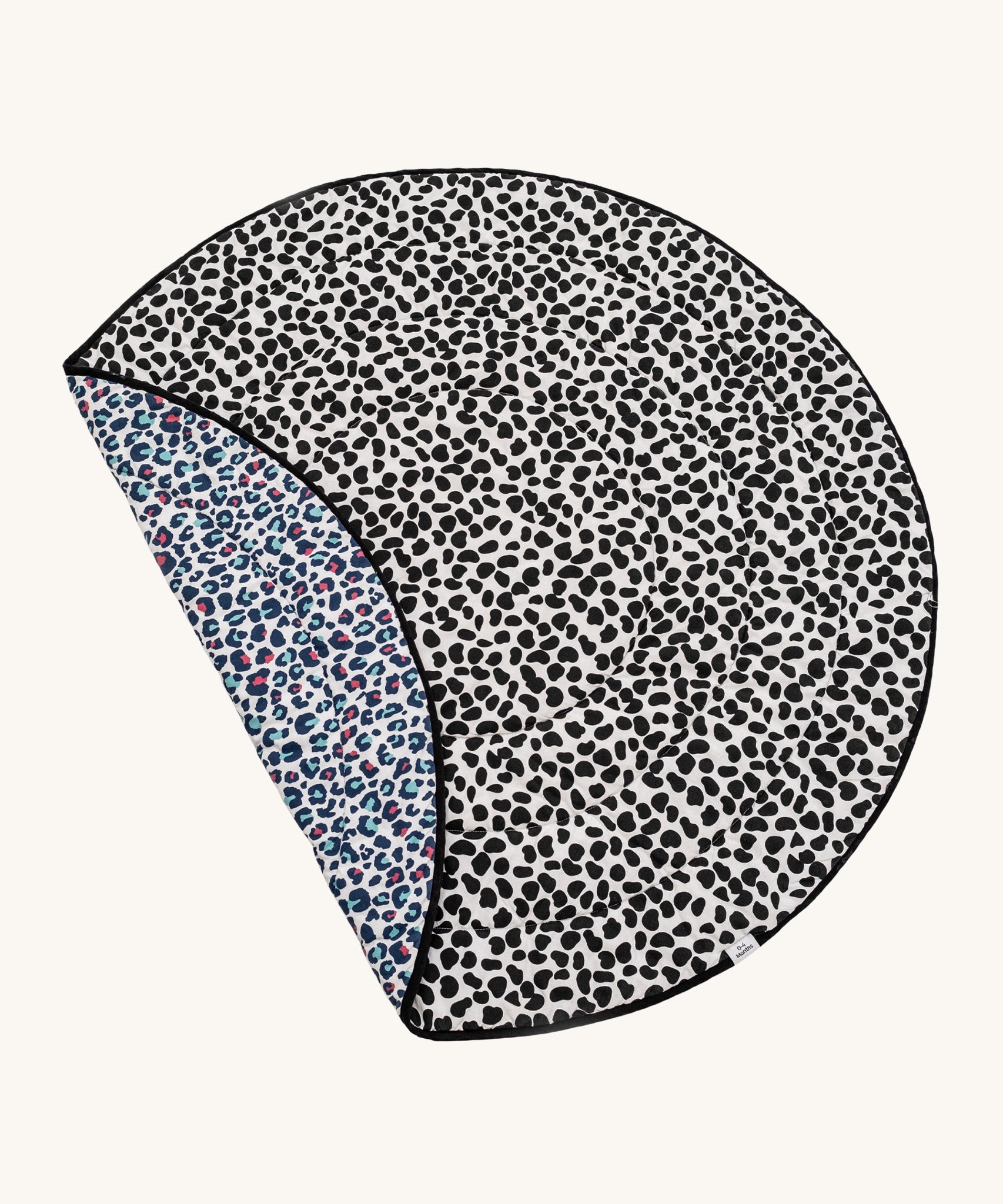 Etta Loves Reversible Organic Cotton Baby Play Mat - Animal Print, with a fun, black, spotty Dalmatian print on one side, and a colourful Leopard print on the other