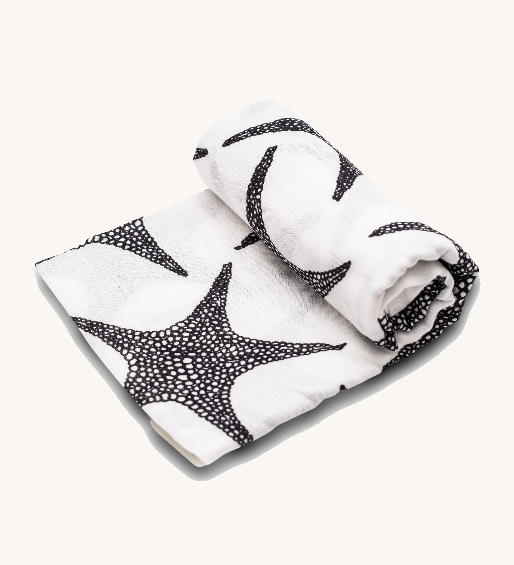 Etta Loves XL Organic Muslin Square. White fabric muslin cloth with black starfish on a cream background