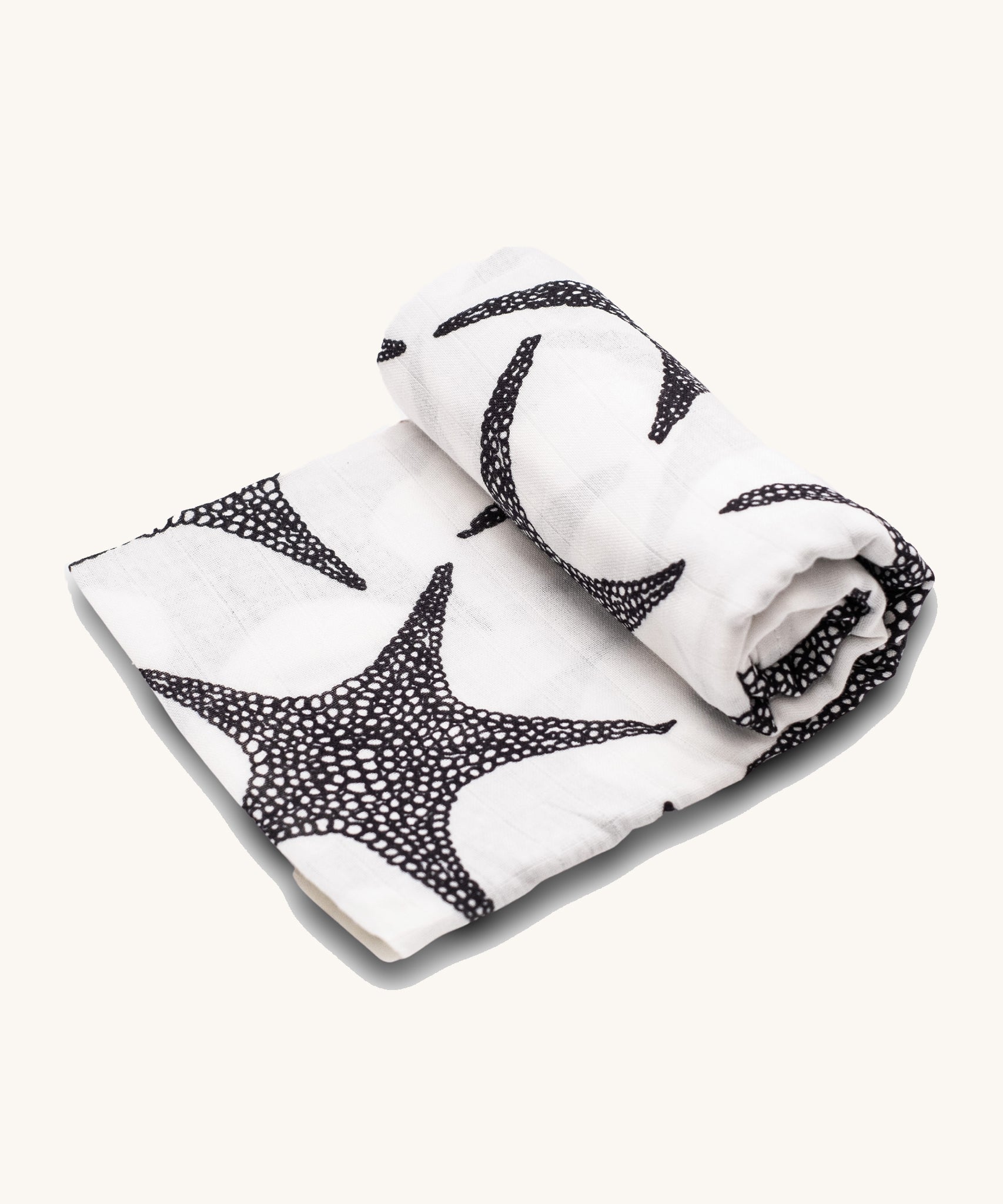 Etta Loves XL Organic Muslin Square. White fabric muslin cloth with black starfish on a cream background