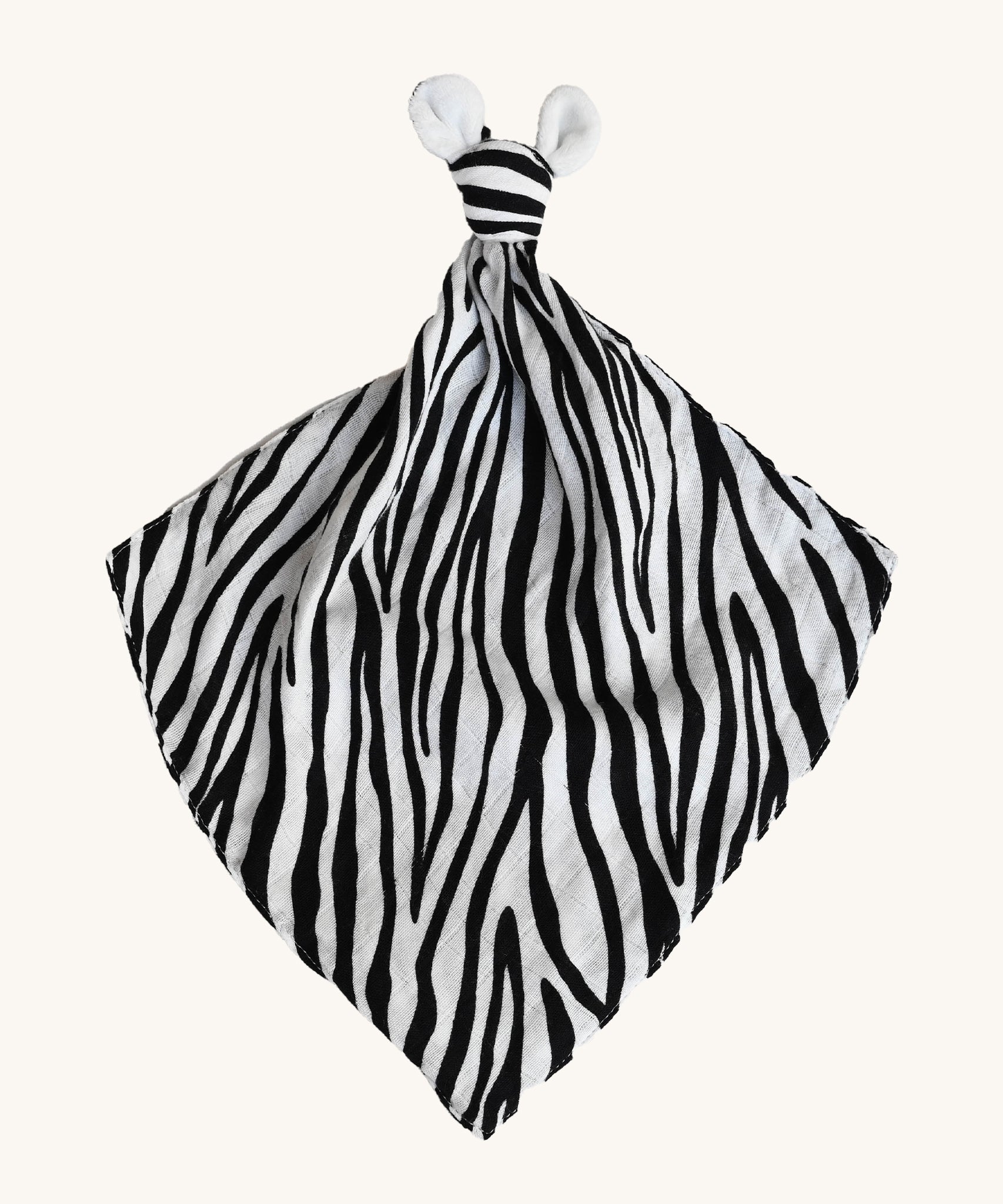 Etta Loves Organic Zebra Comforter in Zebra Print. A soft and cuddly Zebra Print comforter in black and white stripes, a knotted top and two soft zebra ears on a cream background