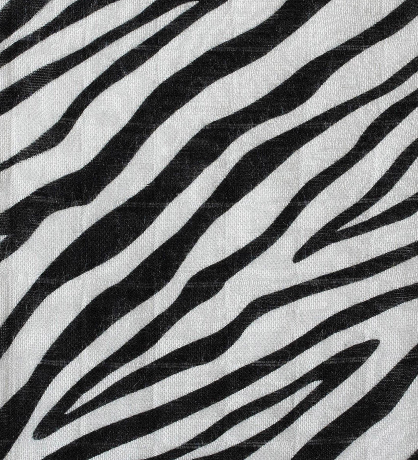  a knotted top and two soft zebra ears on a cream background