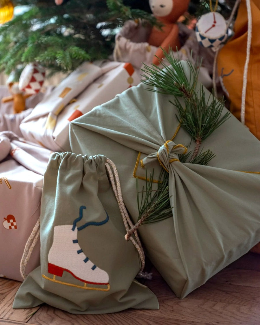 Close up of a Christmas present wrapped in the Fabelab eco-friendly reusable gift wrapping sheets