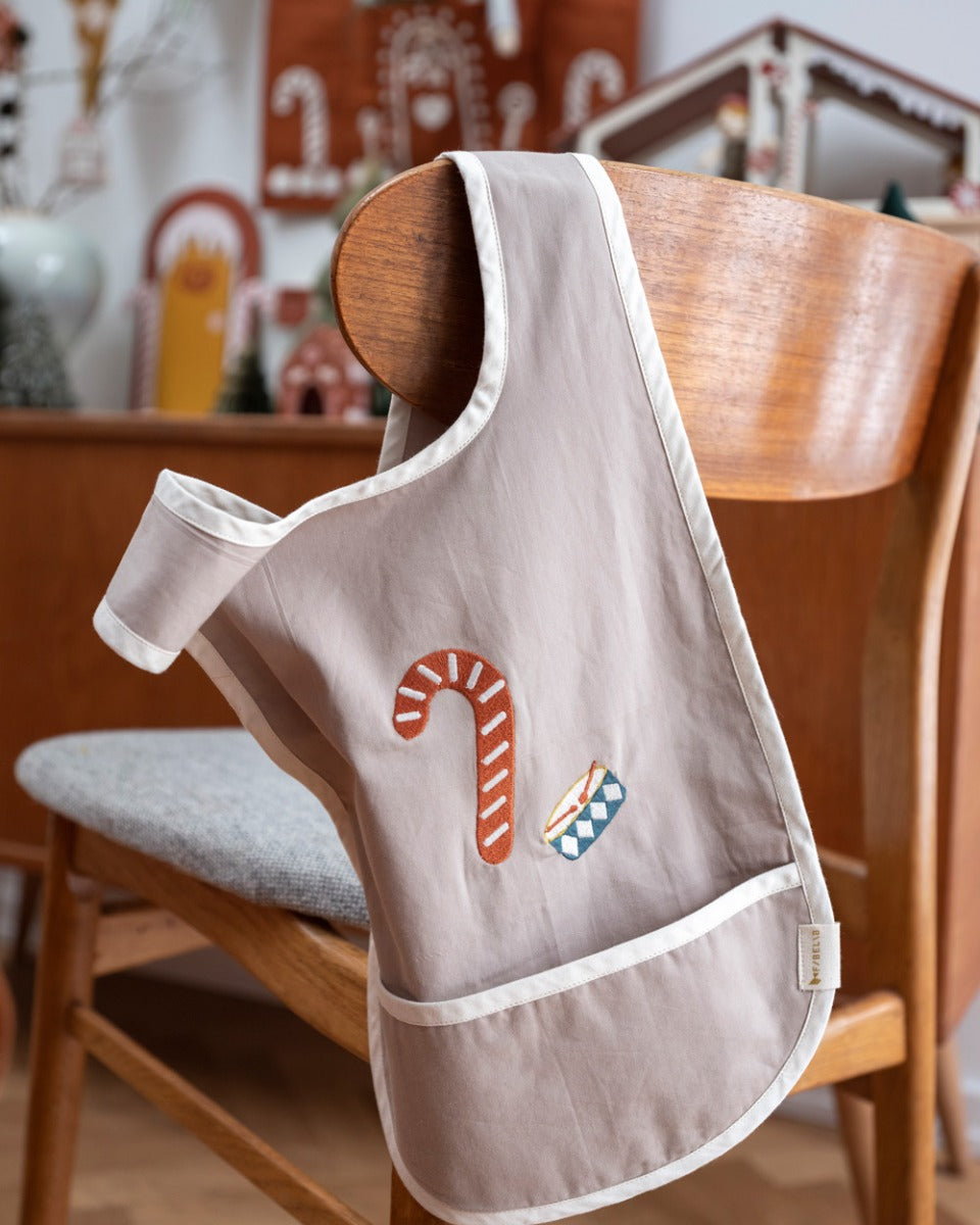 Fabelab kids organic cotton cross back bib with an embroidered candy cane