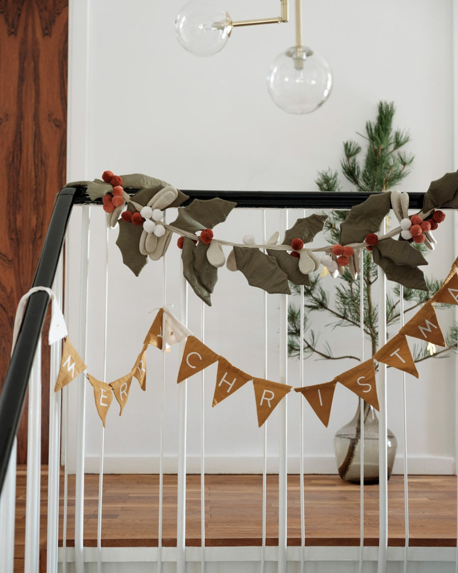 Fabelab eco-friendly reusable fabric garland hanging from some black and white bannisters