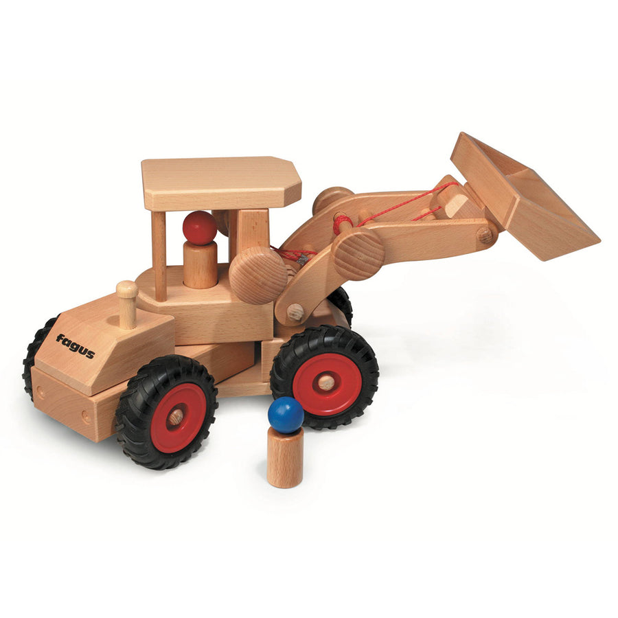 Fagus eco-friendly wheel loader vehicle toy on a white background next to a small wooden peg doll 