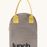 Fluf zip lunch bag in a grey colour with lunch printed on the front in black with a yellow handle and zip detail on a cream background.