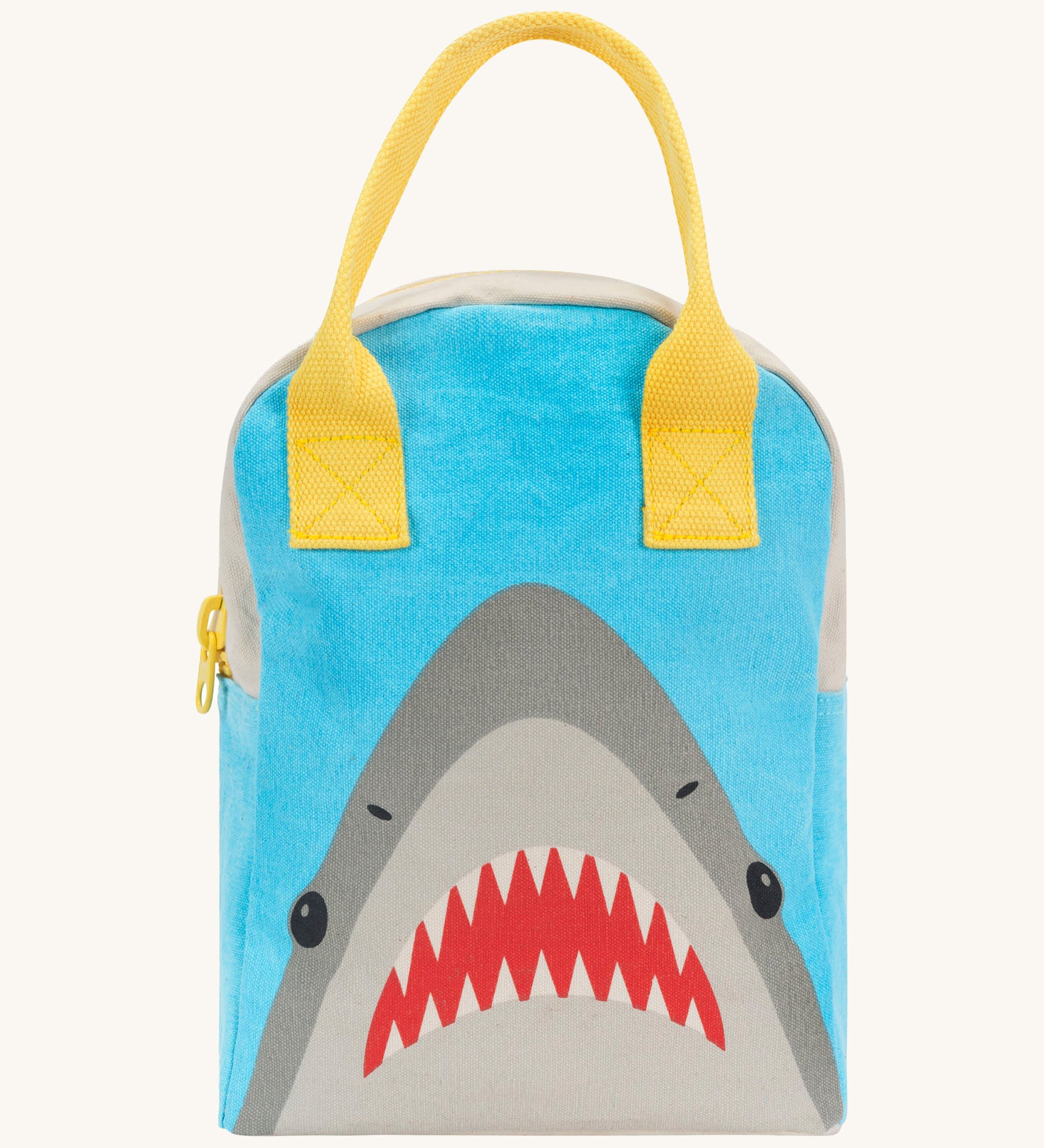 Fluf zip lunch bag in light blue and grey with a design of a shark's head on the bottom with a yellow handle and zip detail on a cream background.