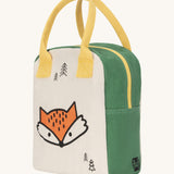 Fluf zip lunch bag in white and green with a design of a fox's head on the bottom with a yellow handle and zip detail on a cream background.