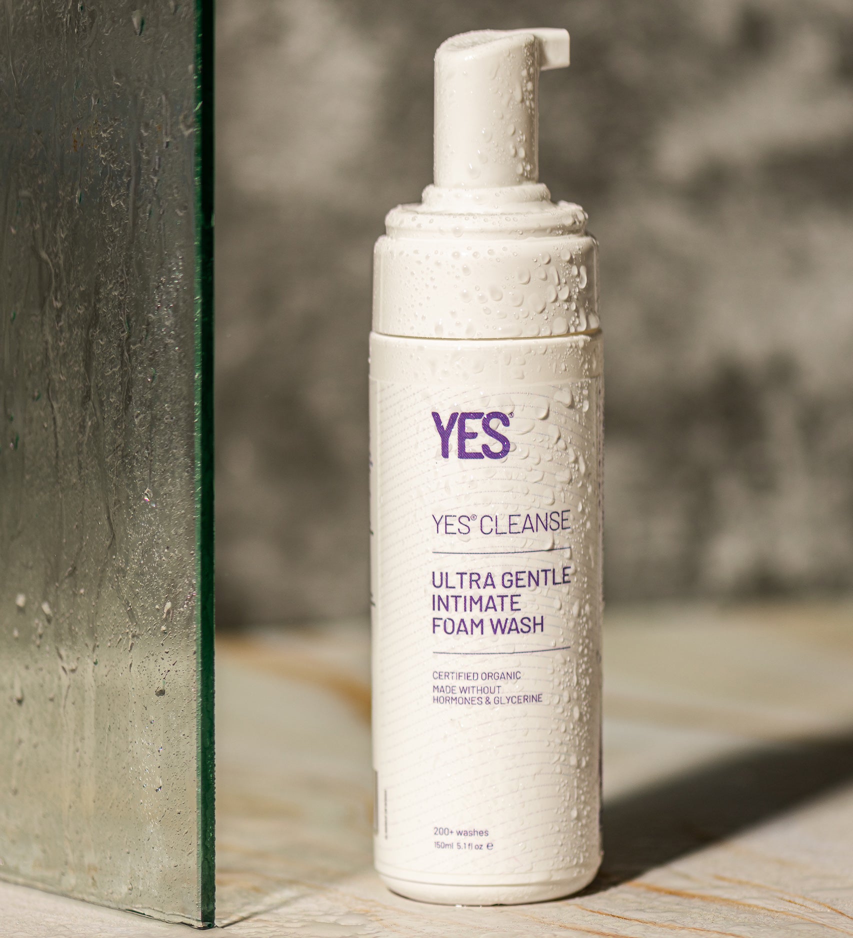 The Yes Cleanse Intimate Wash Fragrance Free -150ml on a shower floor