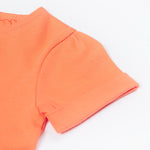 Close up of the Frugi Rowenna outfit, lemur laugh. Showing the sleeve detail on the coral t-shirt on organic cotton fabric