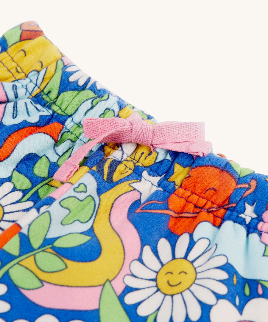 A closer look at the light pink drawcord on the Frugi Snuggle Crawlers - Retro Happy. The image also shows the retro happy print of the trousers