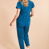 Woman wearing the Frugi Adult deep sea blue coloured Hannah Maternity Jumpsuit showing the back of the outfit