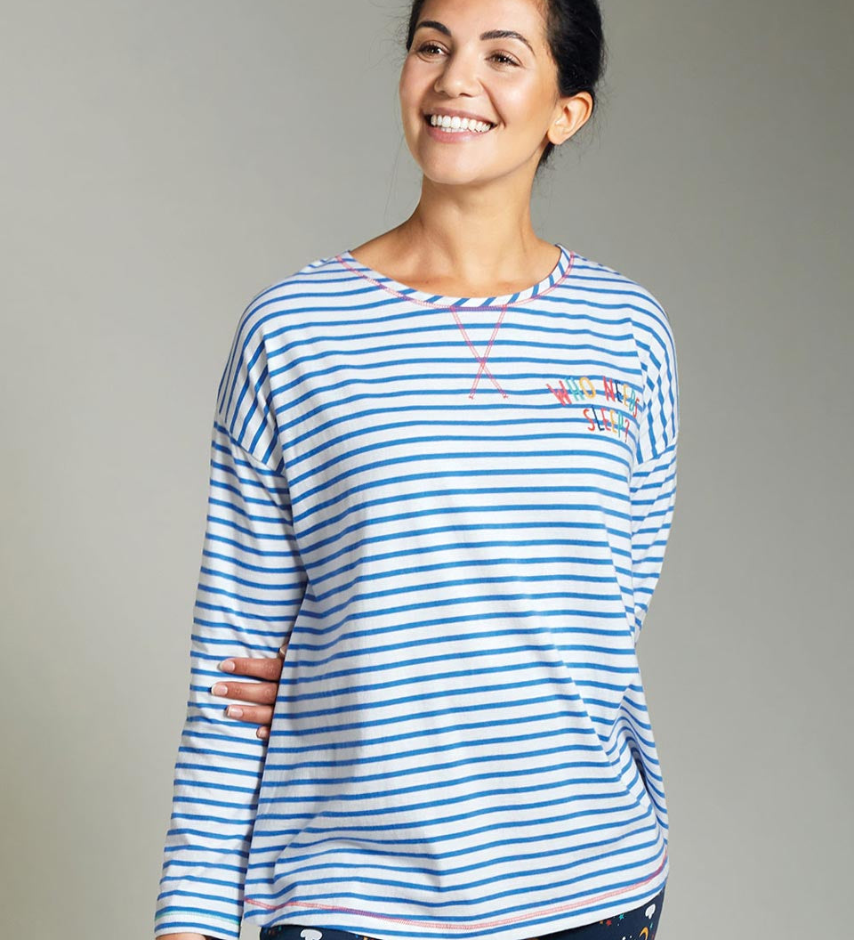 Woman wearing the Frugi eco-friendly meg maternity and nursing striped pyjama top on a grey background