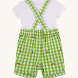 Frugi kids Alfred dungarees outfit, macaw gingham carrots - GOTS organic cotton kids dungaree outfit with a white short sleeve t-shirt and green gingham dungaree with a elasticated waist band. Features orange carrots embroidery scattered on the dungaree. 