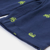 Close up of the Frugi baby short navy tractor dungarees. Showing the turn up detail and green tractor embroidery on navy organic cotton fabric.