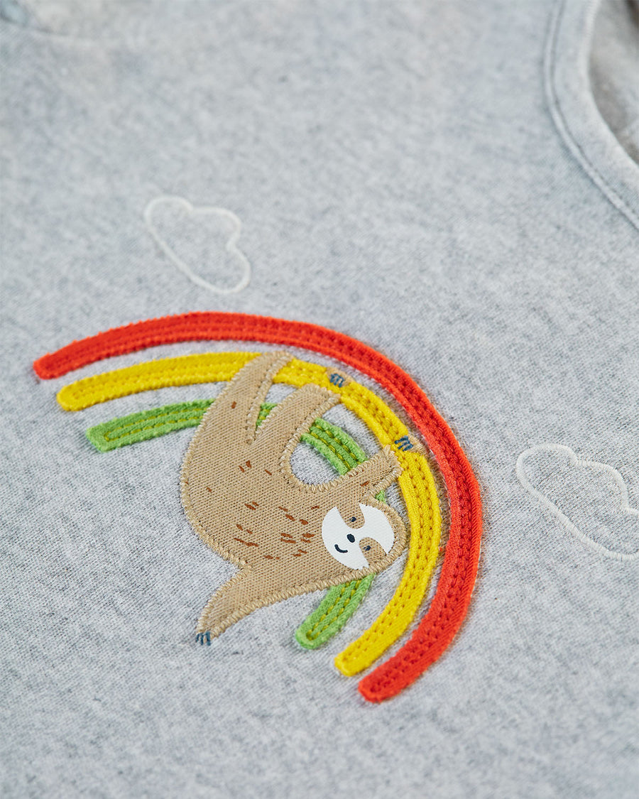 A close up view of the sloth and rainbow applique on the grey top of the Frugi Children's GOTS Organic Cotton Frankie Summer Outfit - Sleepy Sloths.