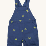 Frugi baby short navy tractor dungarees - GOTS organic cotton baby dungarees in navy blue with a button settings on the shoulder straps for easy fitting. Features a yellow tractor embroidery all over the dungarees.