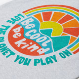 Close up of the Frugi kids be cool carsen printed t-shirt. Showing the vibrant outdoor graphic print with 'Be cool be kind' slogan on top of the graphic on grey organic cotton fabric