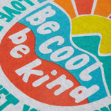 Close up of the Frugi kids be cool carsen printed t-shirt. Showing the vibrant outdoor graphic print with 'Be cool be kind' slogan on top of the graphic on grey organic cotton fabric