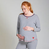 Woman modelling the Frugi long sleeve navy breton striped maternity and nursing pyjama top