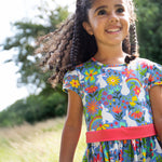 A child wearing the Frugi Bunny Bounce Issey Party Skater Dress