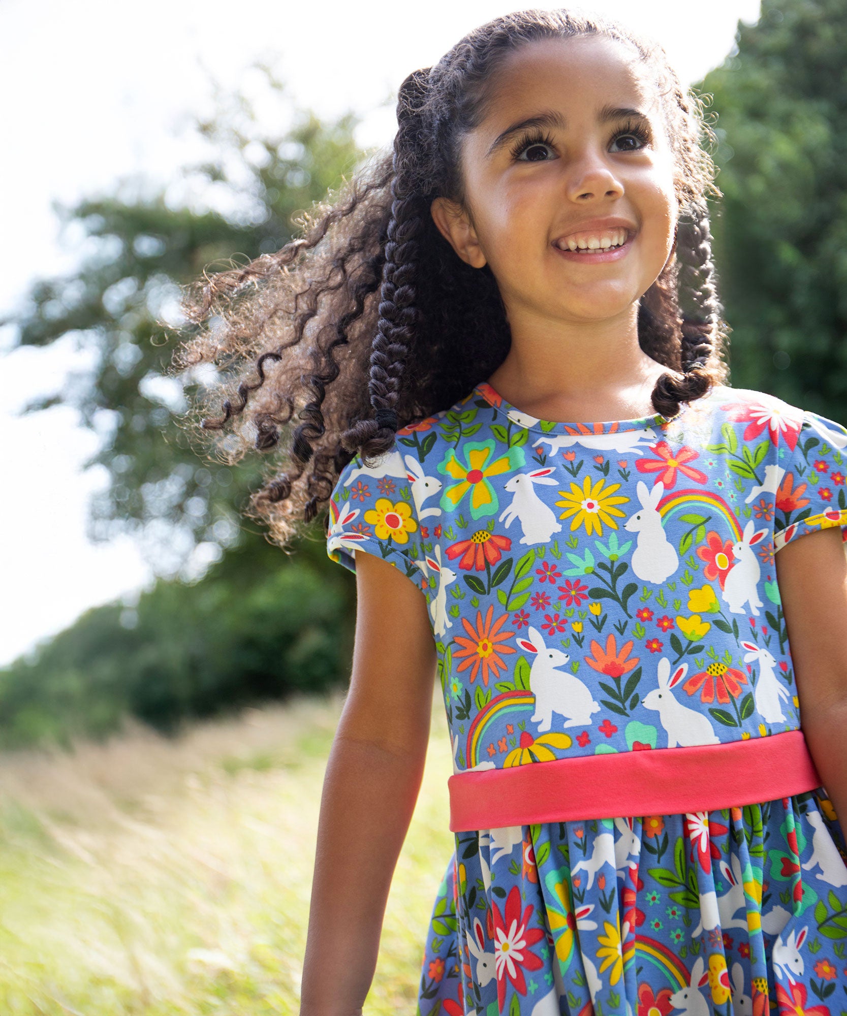 A child wearing the Frugi Bunny Bounce Issey Party Skater Dress