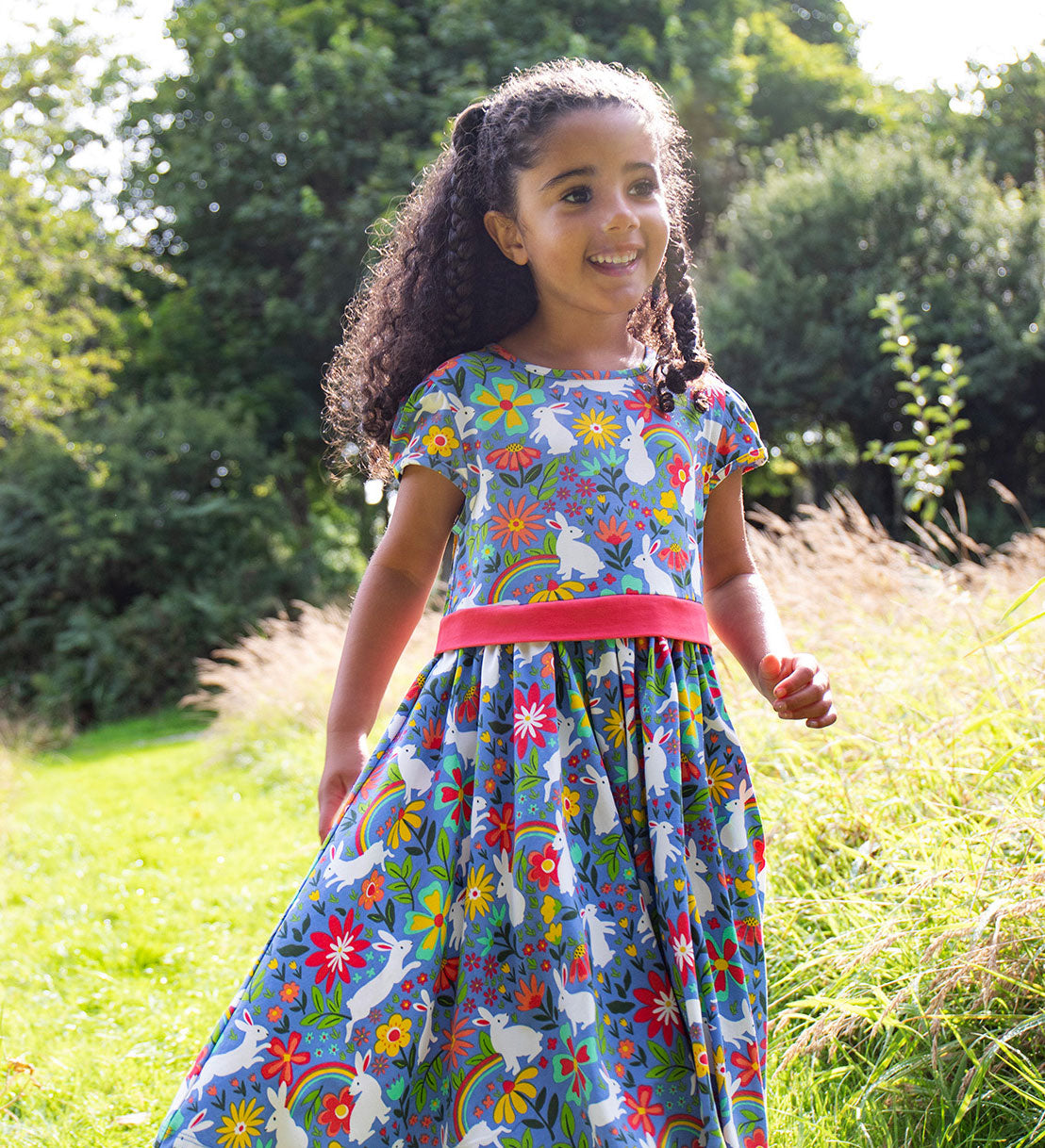 A child wearing the Frugi Bunny Bounce Issey Party Skater Dress