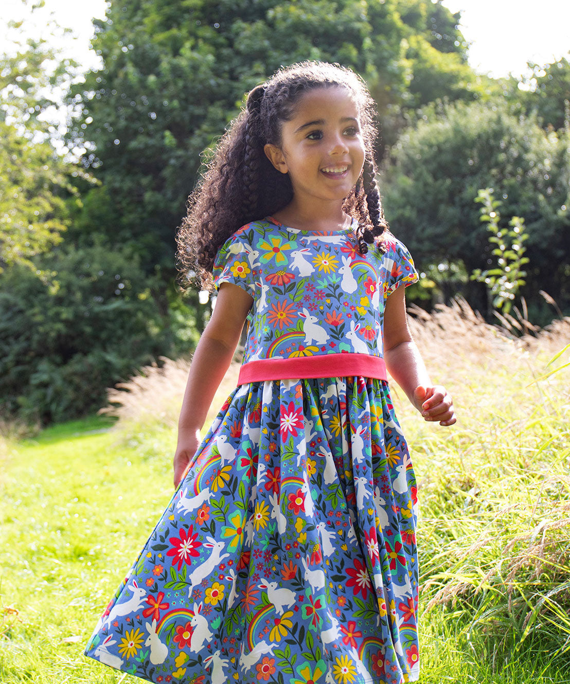 A child wearing the Frugi Bunny Bounce Issey Party Skater Dress