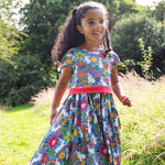 A child wearing the Frugi Bunny Bounce Issey Party Skater Dress